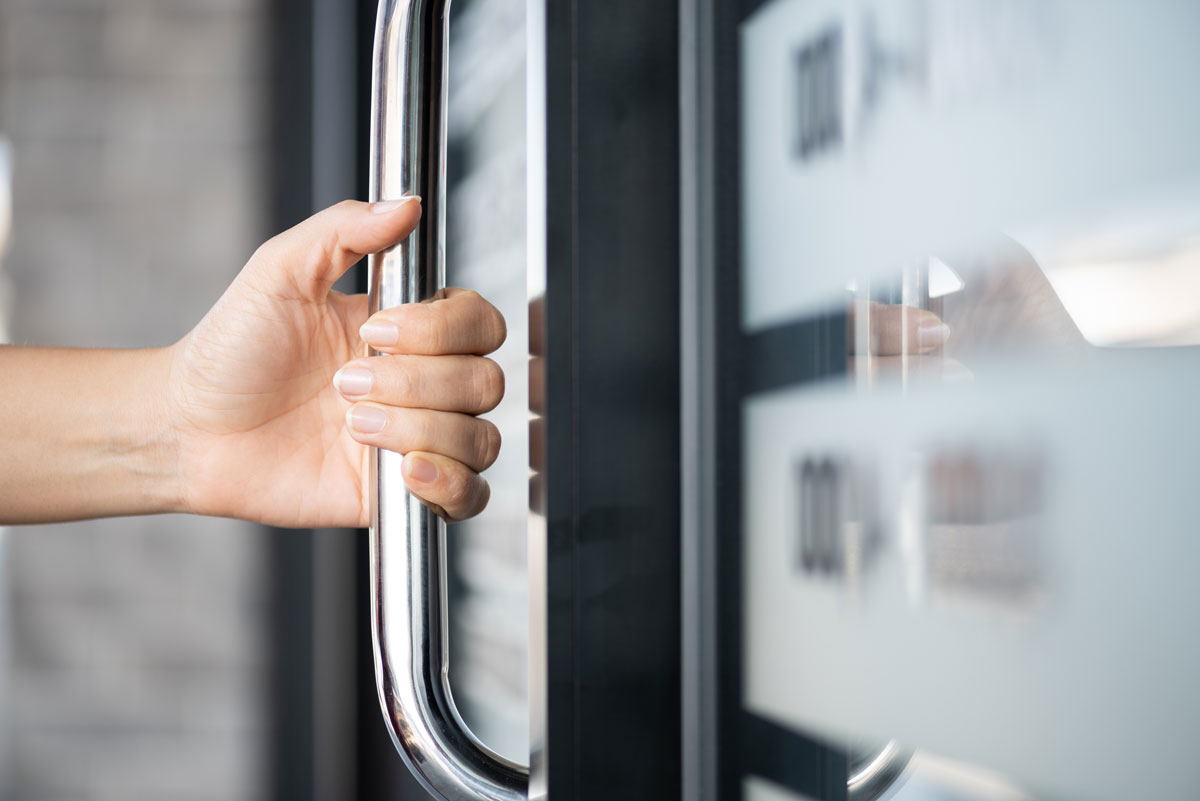 Person opening up a door on way to independent medical examination