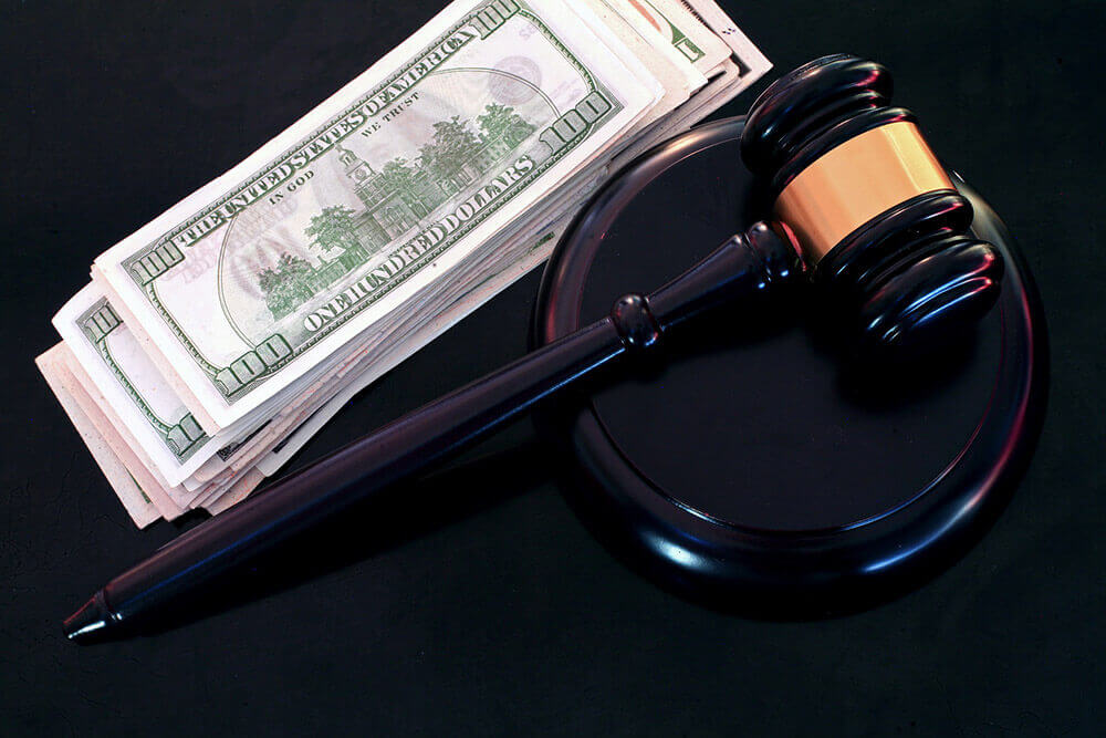 Gavel with a pile of money